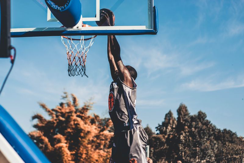 Basketball player jumping for an outdoor dunk