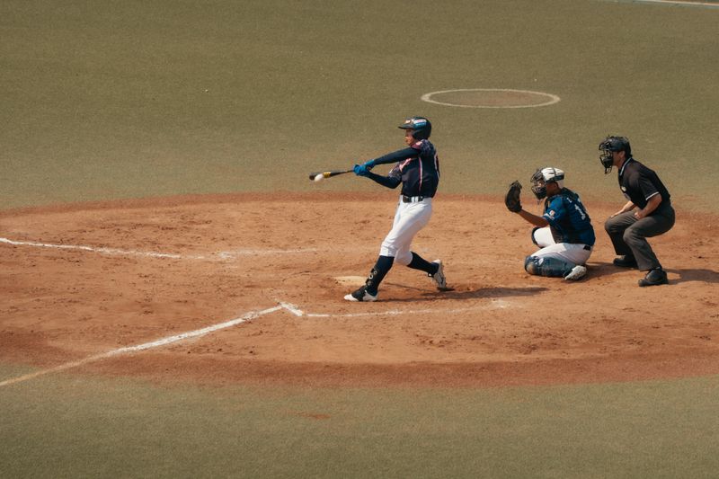 Baseball batter swinging during a game