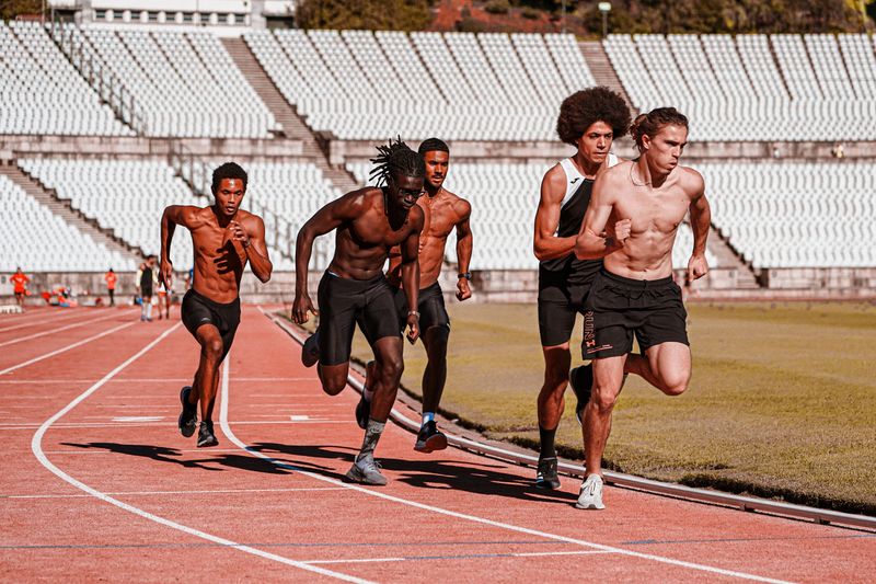 Track athletes sprinting toward the finish