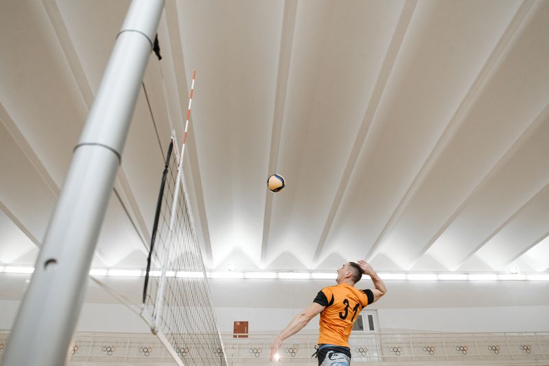Volleyball player jumping to spike at the net
