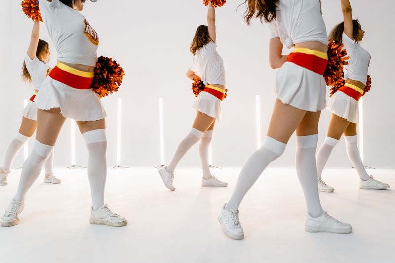 Cheerleaders performing a synchronized pom-pom routine