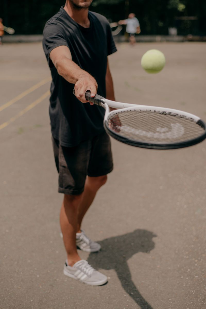 Tennis player meeting the ball with a racket